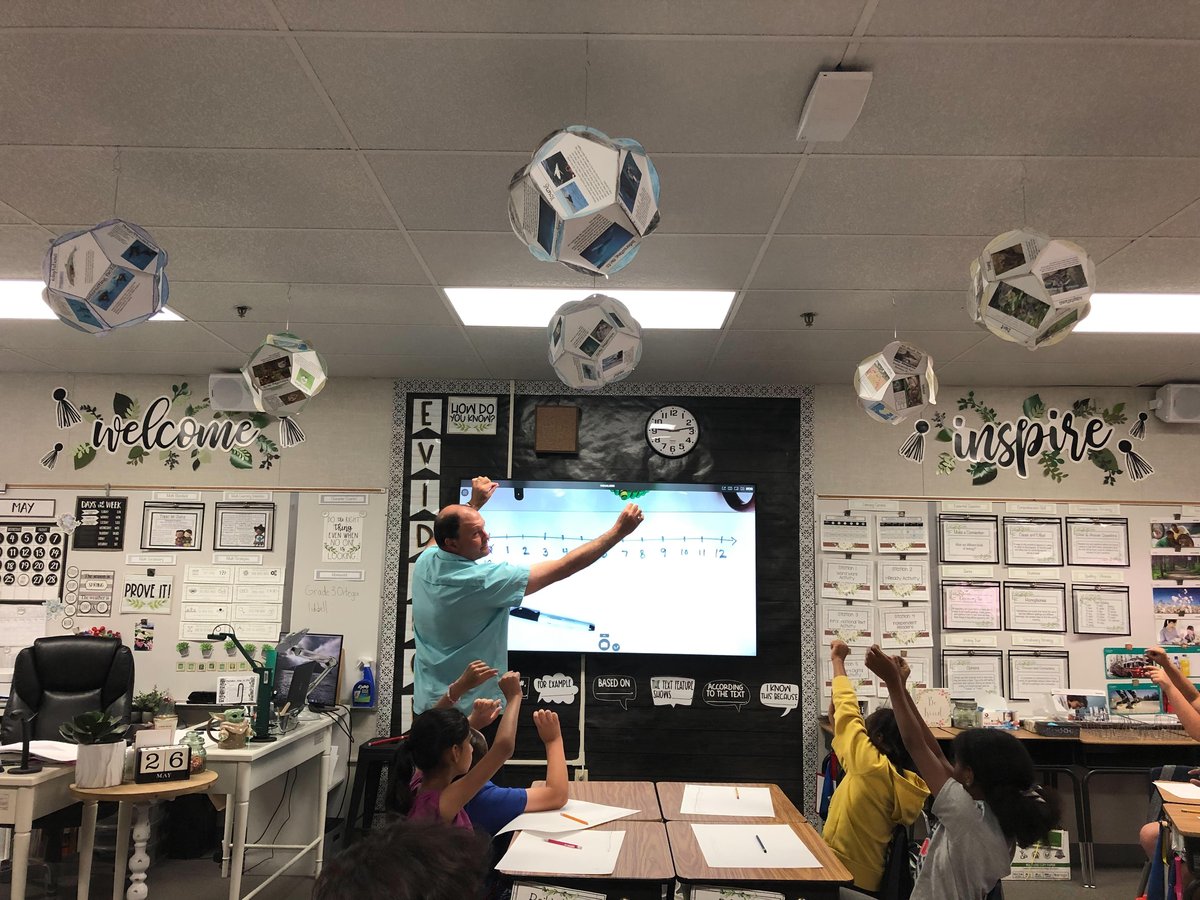 Students building the area model with their teacher