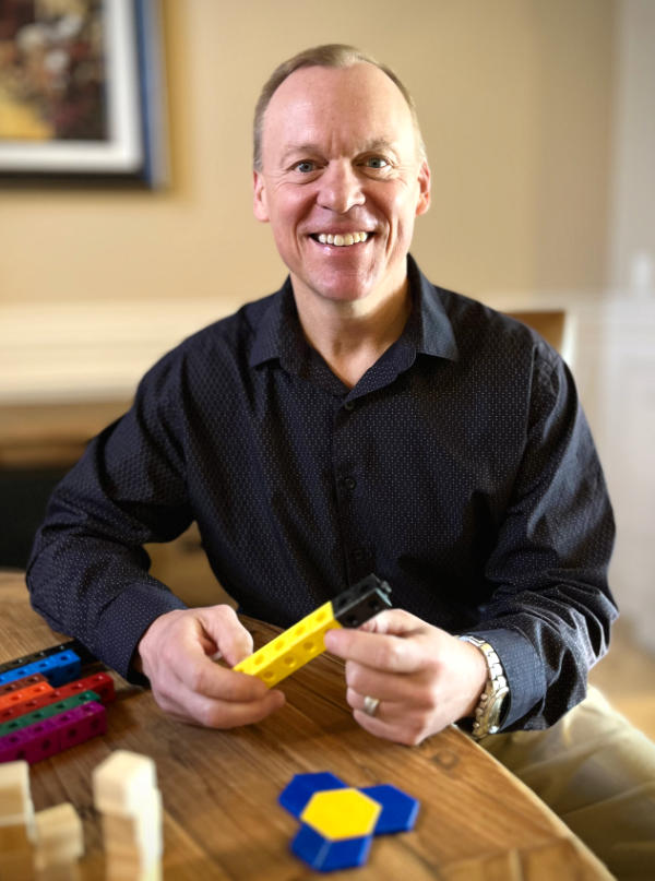 Dr. Jonathan Brendefur laughing with math manipulatives