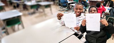 Students holding work