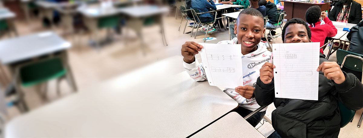 Students holding work
